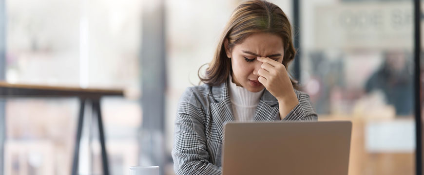 Person Looking at Computer in Shock