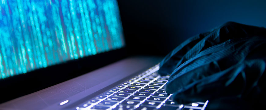 Cybercriminal Working on Computer