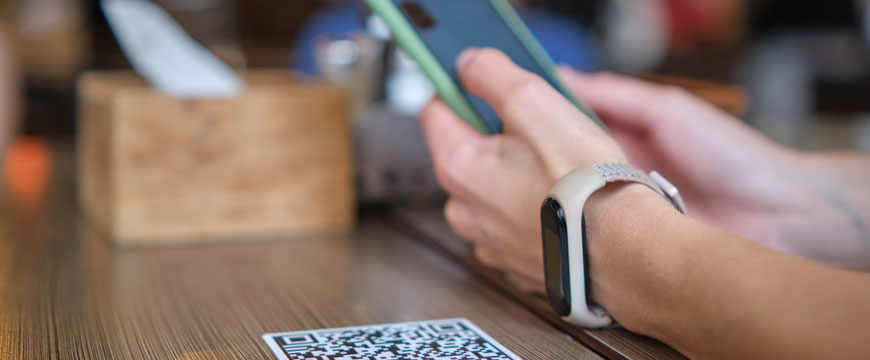 Person on their phone scanning QR Code