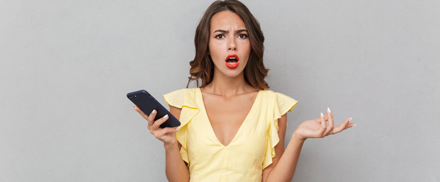 Girl holding a cell phone in confusion