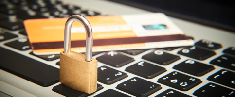Lock with a debit card on top of laptop keyboard