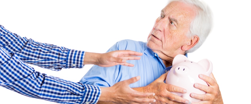 Man protecting piggy bank