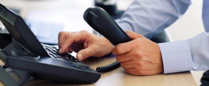 Man dialing telephone